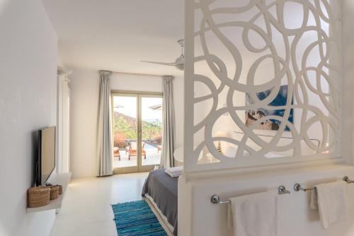 a bedroom with a bed and a large mirror at Sotavento Villa in Fanari