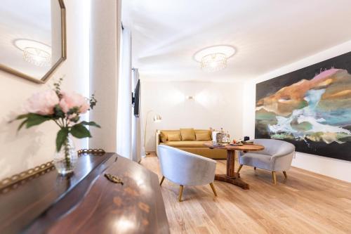 a living room with a couch and a table at De Merin Boutique Hotel Straden in Straden