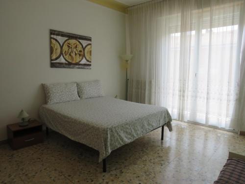 a bedroom with a bed and a large window at La Baia di Lori in Pesaro