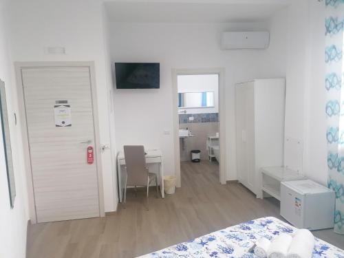 a bedroom with a bed and a desk and a table at B&B 36 Passi dal mare 2.0 in Trapani