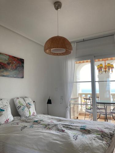 a bedroom with a bed and a table with chairs at Altea Dorada in Altea