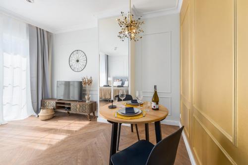 a living room with a table and a tv at Villa 44 in Świnoujście