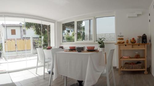 una sala da pranzo con tavolo e sedie bianchi di La Veranda Bed and Breakfast a Ravenna