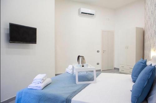 a white room with a bed and a sink at Brighter's Room in Naples