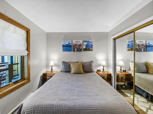 a bedroom with a large bed with two lamps at Inner Circle 3 Condo in Breckenridge
