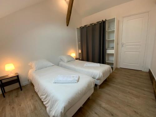 two beds in a small room with a closet at La MAIS'ANGE - Charmante maison proche centre in Blois