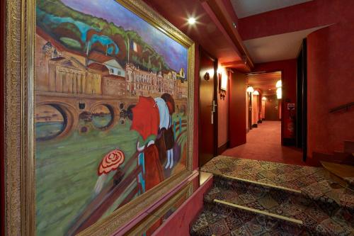 a large painting on the wall of a hallway at Grand Hotel de l'Opera - BW Premier Collection in Toulouse