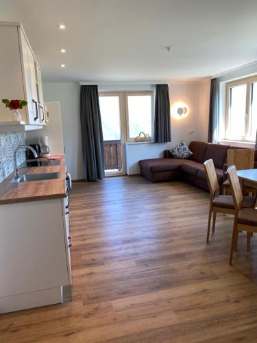 a living room with a kitchen and a couch at Dachsteinblick in Schladming