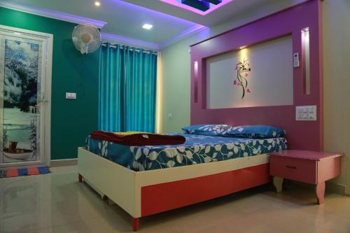 a bedroom with a bed with a purple and green wall at Kandamath Heritage Resort in Kolattupuzha