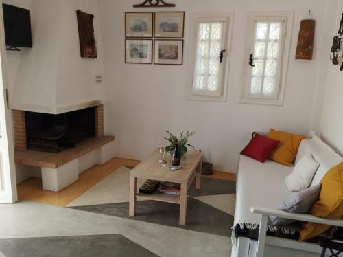 a living room with a couch and a table at Olive Grove Soulis Family Estate in Porto Heli