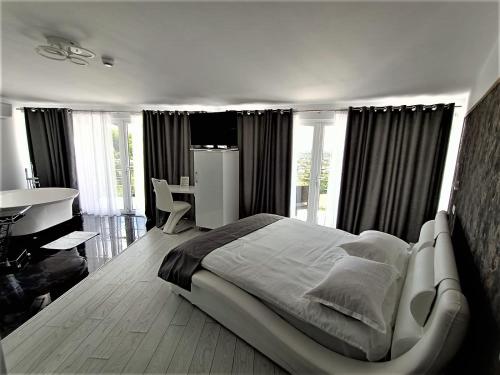 a bedroom with a large bed and a table and a desk at Cazare Casa Noastra in Viforîta