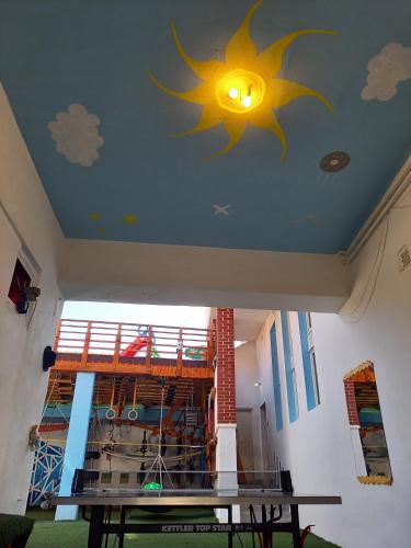a ceiling with a sun and clouds painted on it at Triniti Vendégház in Eger