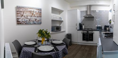 a kitchen with a table and chairs in a room at The Old Paint Shop Apartment - Centrally Situated in Anstruther