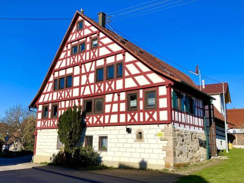 een groot rood-wit gebouw met bij Ferienwohnungen im Eugenhaus in Rosenfeld