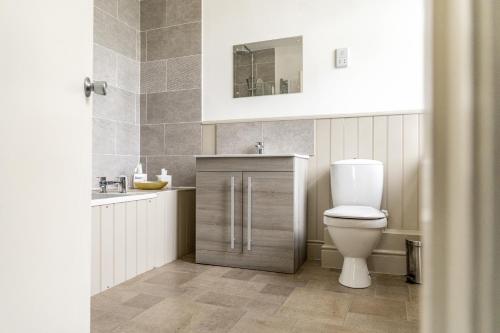 a bathroom with a toilet and a sink at Leigh Park Country House Hotel & Vineyard, BW Signature Collection in Bradford on Avon