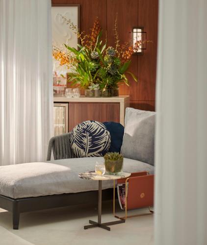 a living room with a couch and a table at Jumeirah Carlton Tower London in London