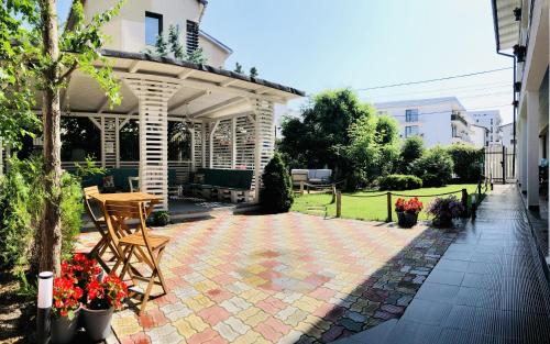 a patio with a gazebo and a table and chairs at Ido in Mamaia Nord