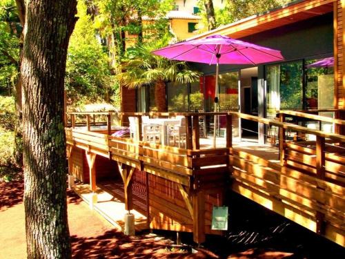 a porch with a pink umbrella on a house at Oasis in Arcachon