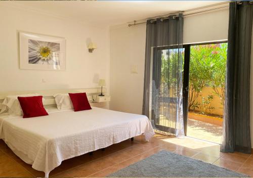 a bedroom with a bed and a large window at Casa Concha - Peaceful and Relaxing in Lagos