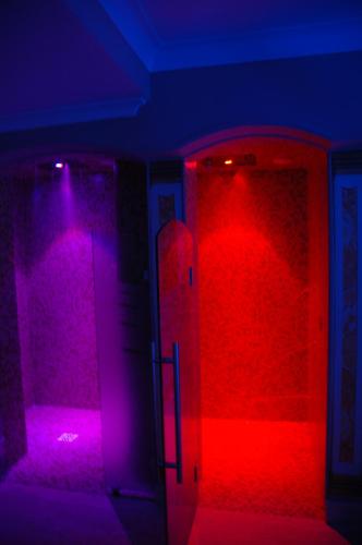a room with red and purple lights and a door at Hotel Argentina & SPA in Fiuggi