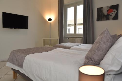 Postel nebo postele na pokoji v ubytování Rho Fiera Flat