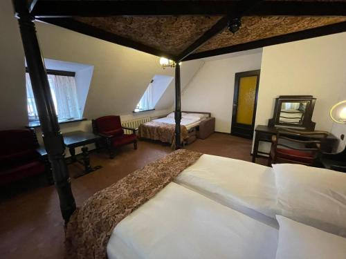 a bedroom with two beds and a desk and a bed at Hotel Dwór Polski in Wrocław
