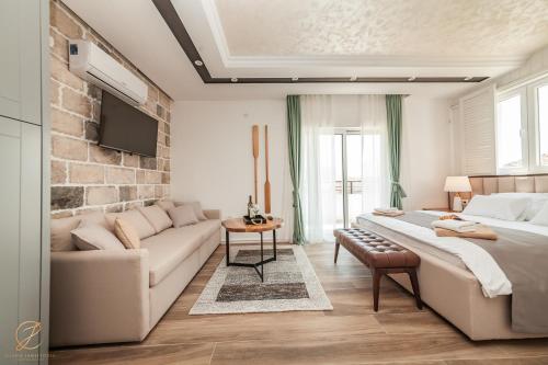 a living room with a bed and a couch at Apartments Cukovic in Herceg-Novi