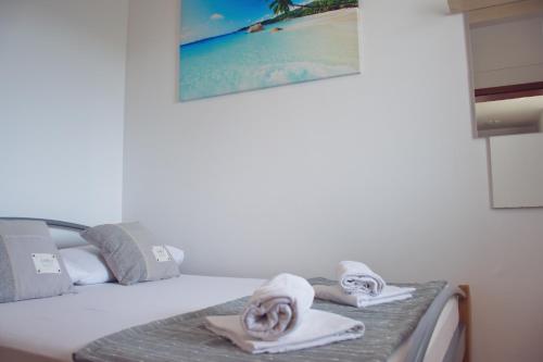 a bedroom with a bed with towels on it at Apartment Noel in Novalja