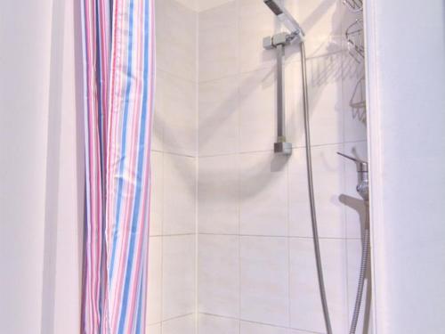 a bathroom with a shower with a shower curtain at StudioLille - Beaux-Arts in Lille