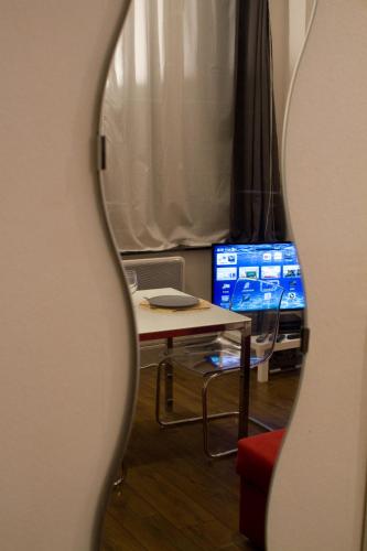 a mirror reflection of a table and a tv at StudioLille - Beaux-Arts in Lille
