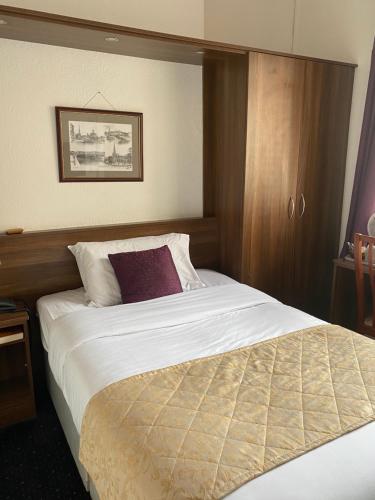 a large bed in a hotel room with at The Tudor Hotel in Bridgwater