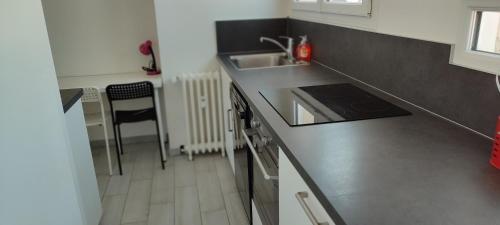 a kitchen with a sink and a counter top at Appartement 83 m2, 4 lits , 5 Pers, 100 m de la gare, Confortable et Lumineux in Le Havre