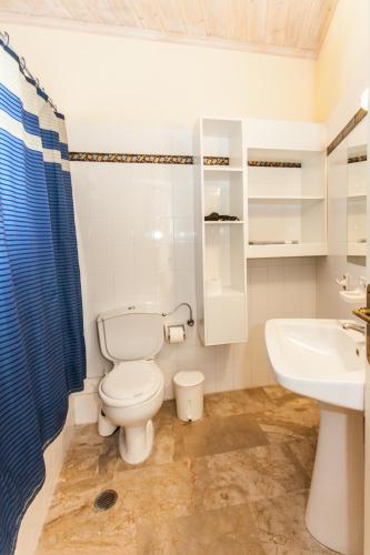a bathroom with a toilet and a sink at Lido Apartments Tolo in Tolo