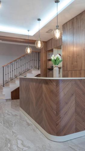 a staircase in a house with a reception counter with lights at Garden Recovery in Sveti Stefan