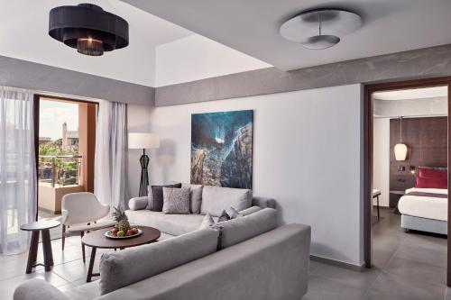 a living room with a couch and a bed at Atlantica Caldera Palace in Hersonissos