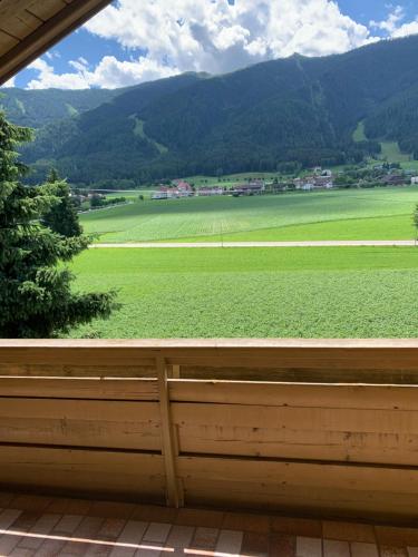 a view of a green field from a window at Appartments Hilber in Brunico