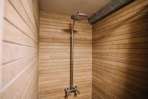 a shower in a bathroom with wooden walls at Villa Allure of Dubrovnik in Dubrovnik