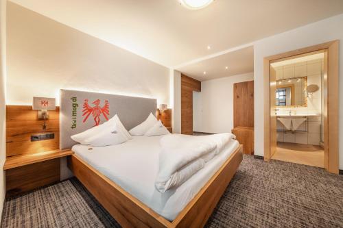 Postel nebo postele na pokoji v ubytování Kräuterhotel Hochzillertal