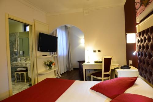 Postel nebo postele na pokoji v ubytování Trilussa Palace Hotel Congress & Spa