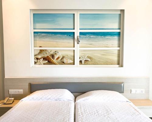 a bedroom with a window view of the beach at Anesis Hotel in Ayia Napa