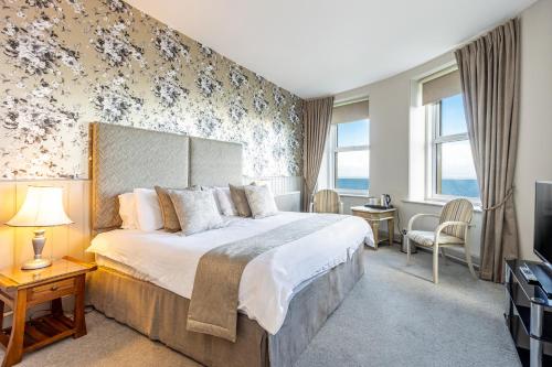 a hotel room with a large bed and a television at Best Western Walton Park Hotel in Clevedon