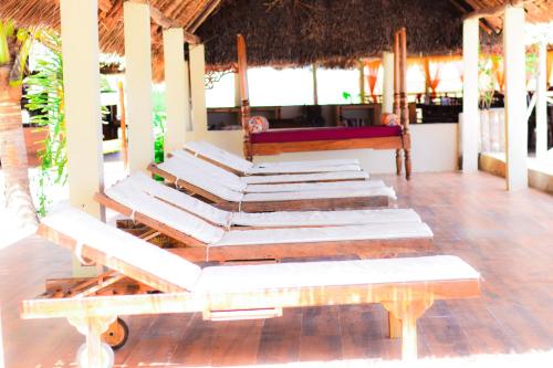 a group of towels on a table and a bench at Kikoi Boutique Hotel in Michamvi