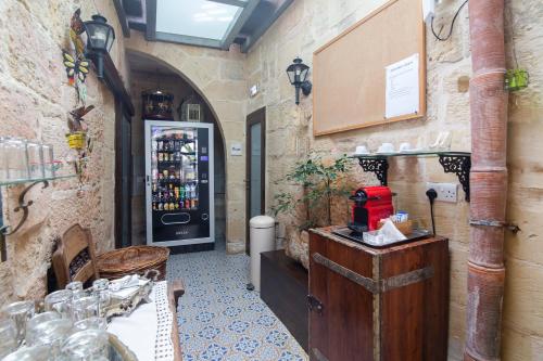 a wine tasting room with a refrigerator in a restaurant at The Burrow Guest House in Tarxien