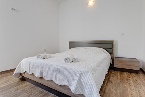 a bedroom with a bed with two towels on it at Apartments LungoMare in Tivat