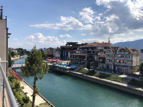 a view of a river with houses and buildings at Apartment N & N in Struga