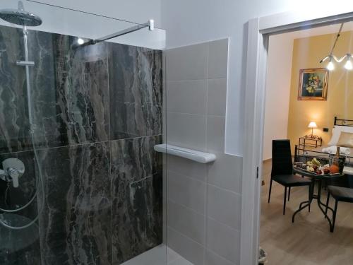 a bathroom with a shower and a table at B&B 36 Passi dal mare 2.0 in Trapani