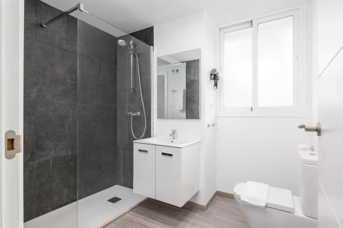 a white bathroom with a shower and a sink at iloftmalaga Ricardo Soriano in Marbella