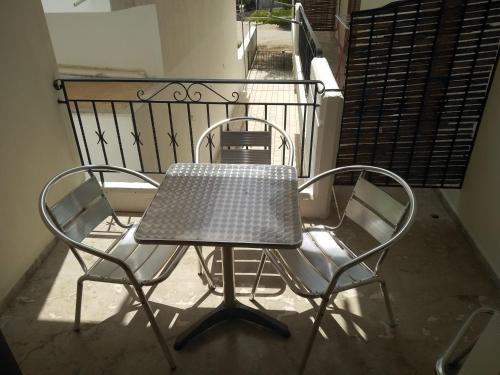 a table and two chairs on a balcony at Πενυ Καντια 1ος Ν 4 in Kandia