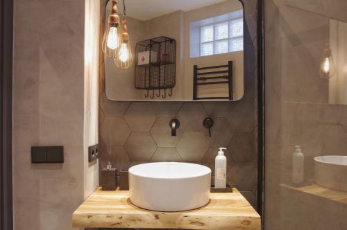 a bathroom with a white tub and a sink at Apartamentos Bahia San Lorenzo in Gijón