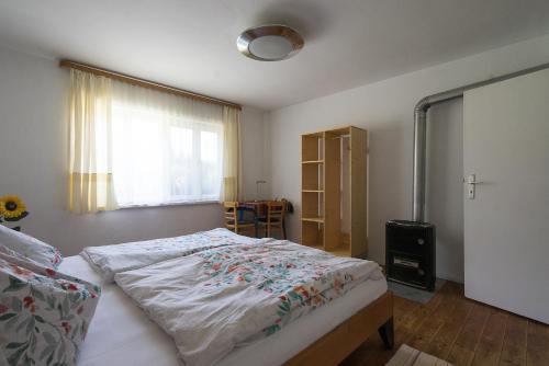 a bedroom with a bed and a window at Baumzelt im Wald in Regen